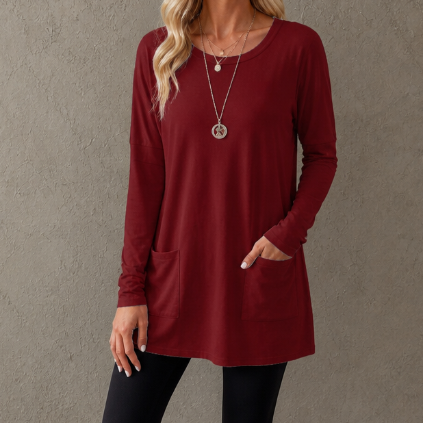 Harlow tunic top, back view paired with leggings and sneakers