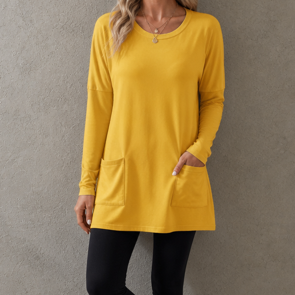 Harlow tunic top, back view paired with leggings and sneakers