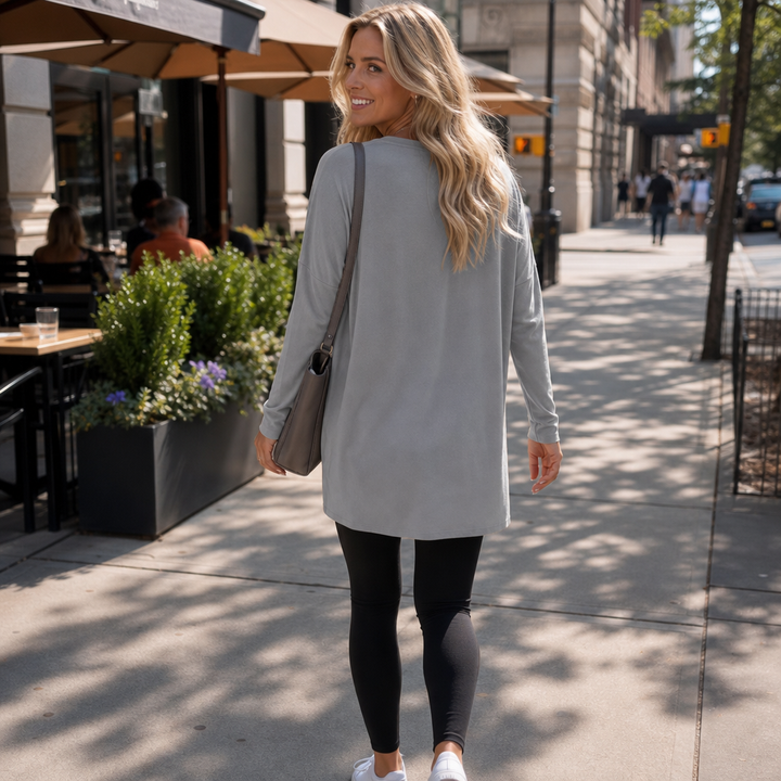 Harlow tunic top, back view paired with leggings and sneakers