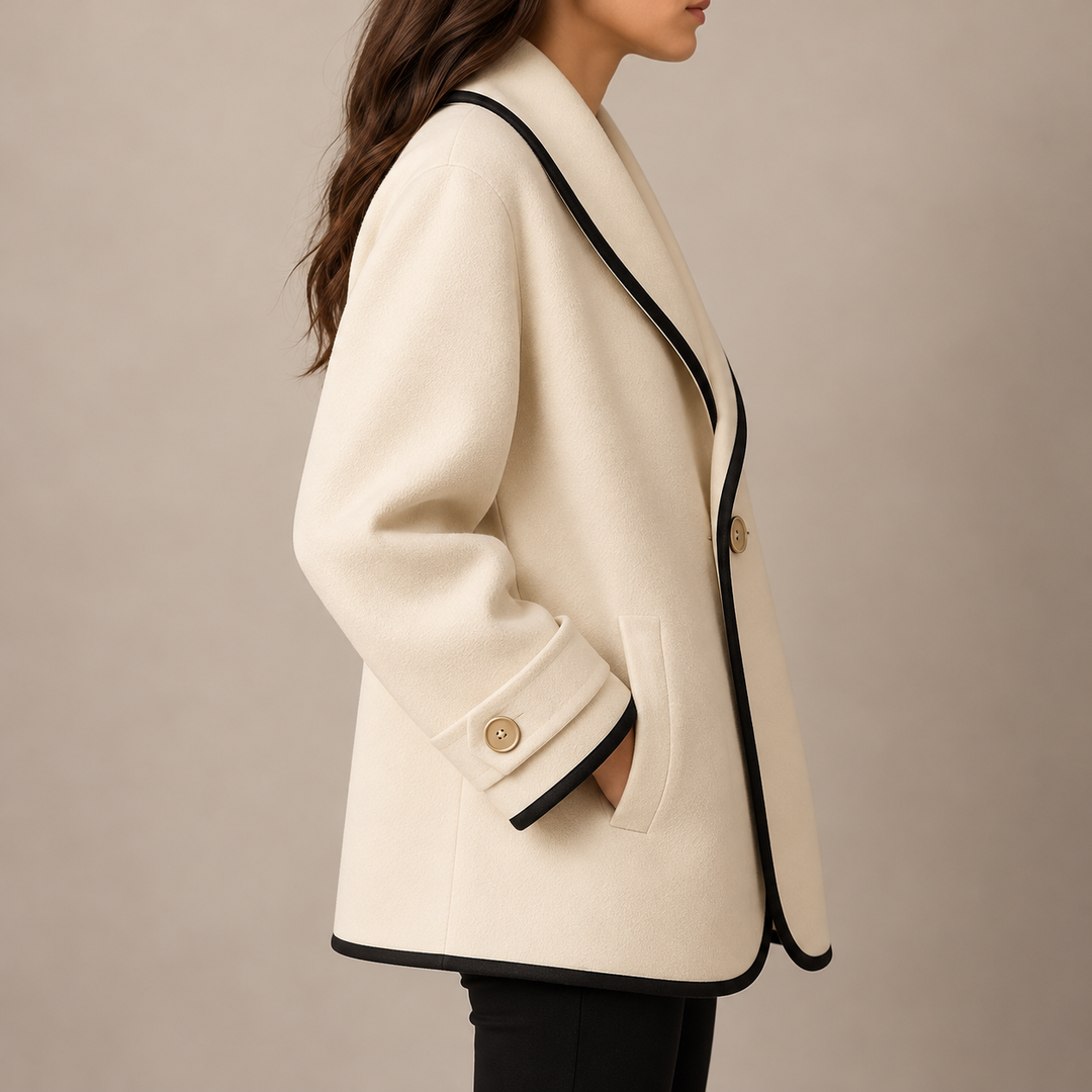 Delphine wool coat side view showing turned-back cuff and pocket detail