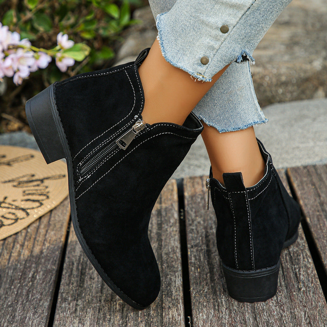 Verlaine black ankle boots, crossed-leg front view