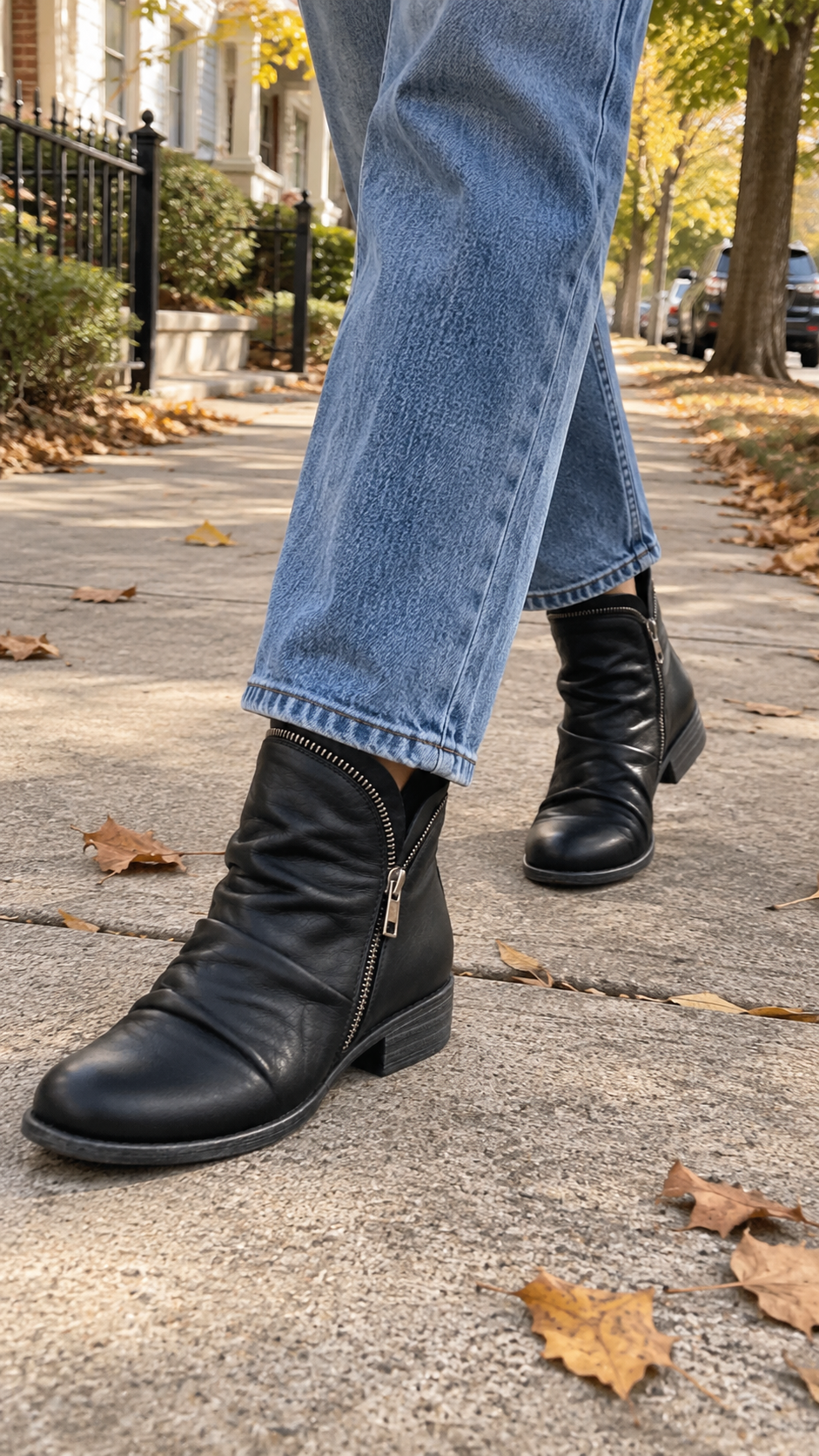 Marisol black slouch ankle boots worn outdoors with jeans, walking shot