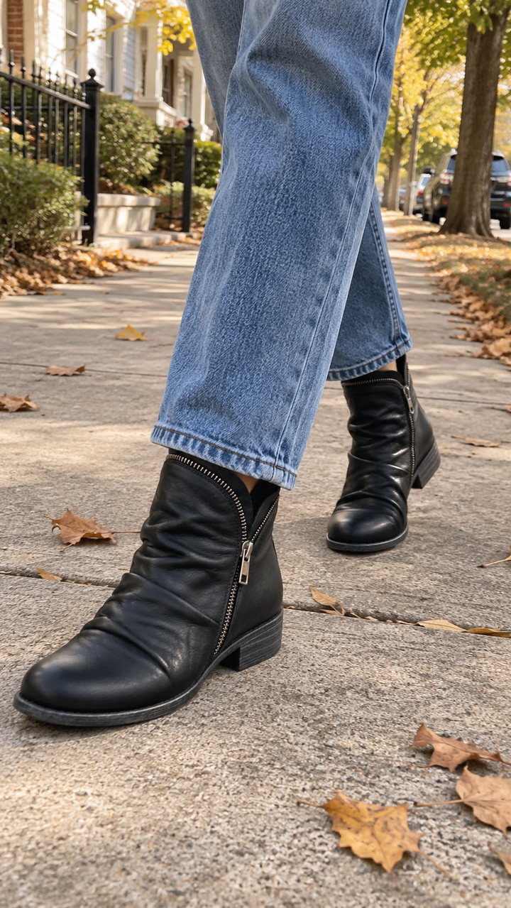 Marisol black slouch ankle boots worn outdoors with jeans, walking shot
