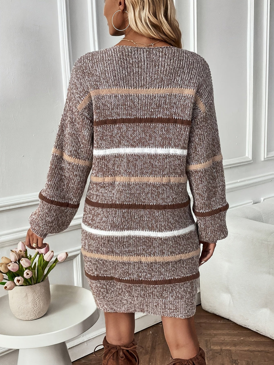 Adeline striped sweater dress front view with model holding phone