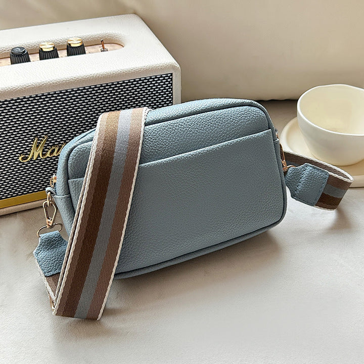 Vivienne khaki leather crossbody bag with striped strap, side view