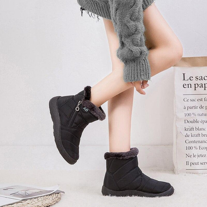 Marcelline brown ankle snow boots with fur collar, pair on flooring