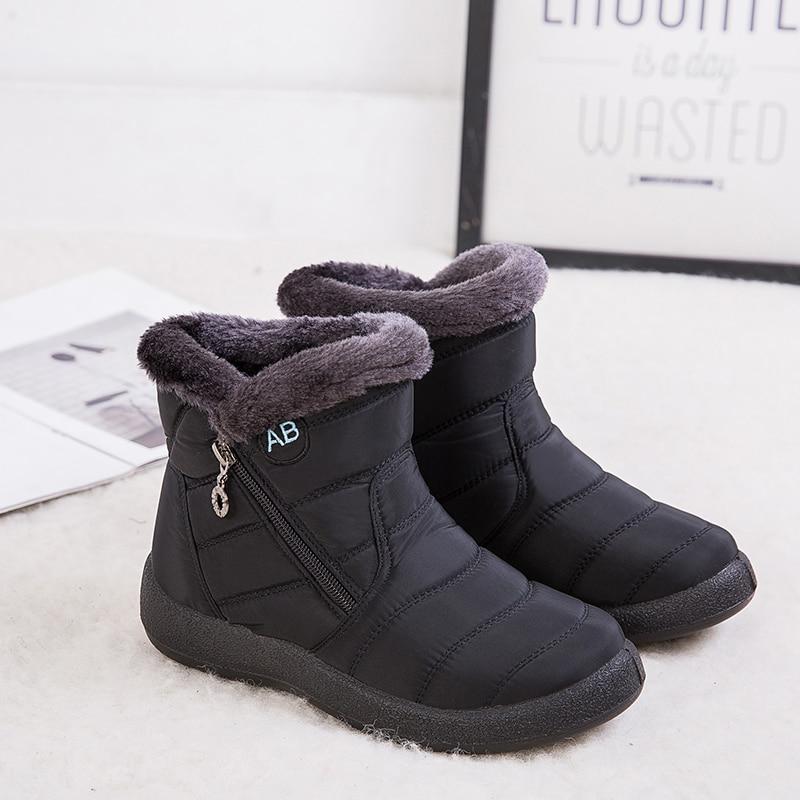 Marcelline brown ankle snow boots with fur collar, pair on flooring