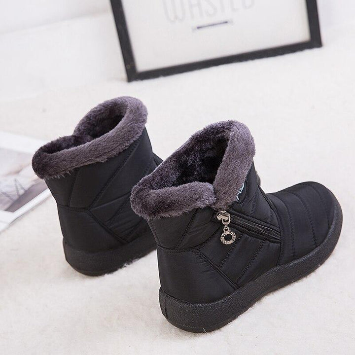 Marcelline brown ankle snow boots with fur collar, pair on flooring