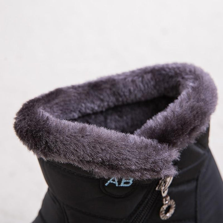 Marcelline brown ankle snow boots with fur collar, pair on flooring