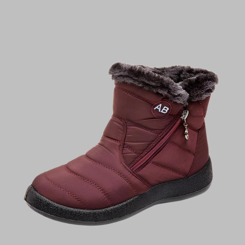 Marcelline brown ankle snow boots with fur collar, pair on flooring