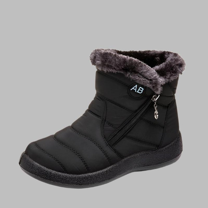 Marcelline brown ankle snow boots with fur collar, pair on flooring