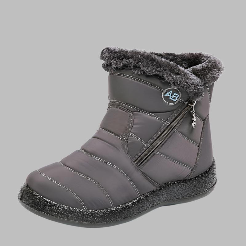 Marcelline brown ankle snow boots with fur collar, pair on flooring