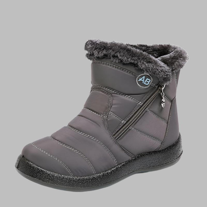 Marcelline brown ankle snow boots with fur collar, pair on flooring