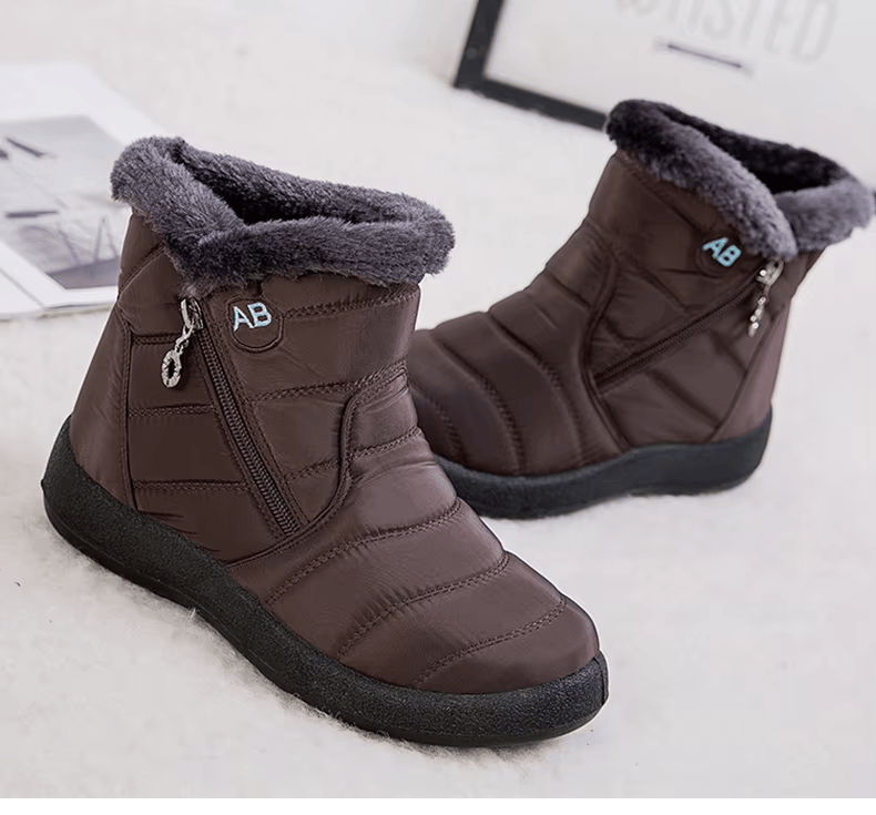 Marcelline brown ankle snow boots with fur collar, pair on flooring