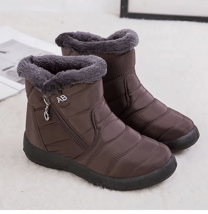 Marcelline brown ankle snow boots with fur collar, pair on flooring