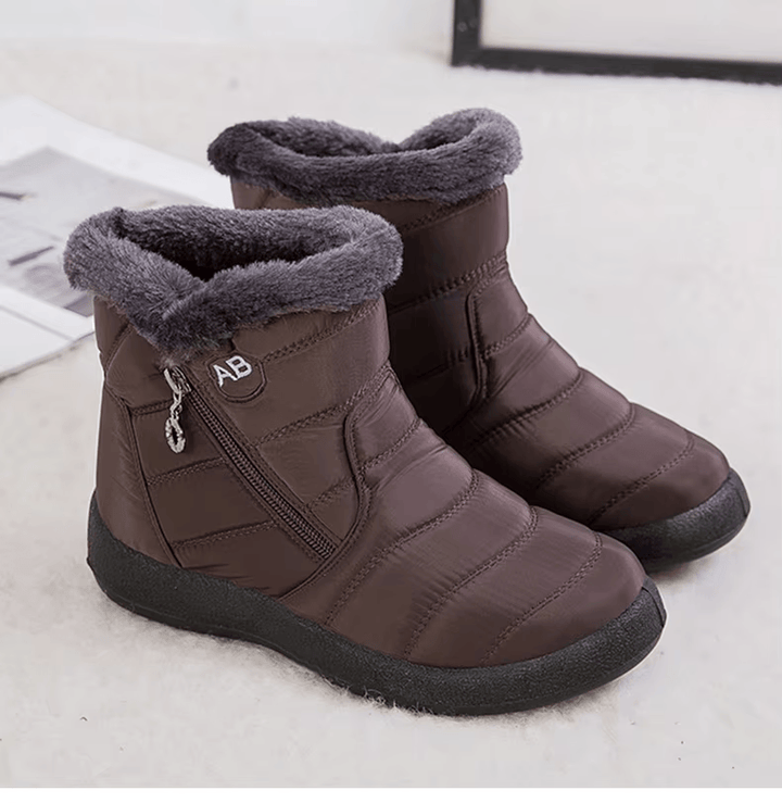 Marcelline brown ankle snow boots with fur collar, pair on flooring