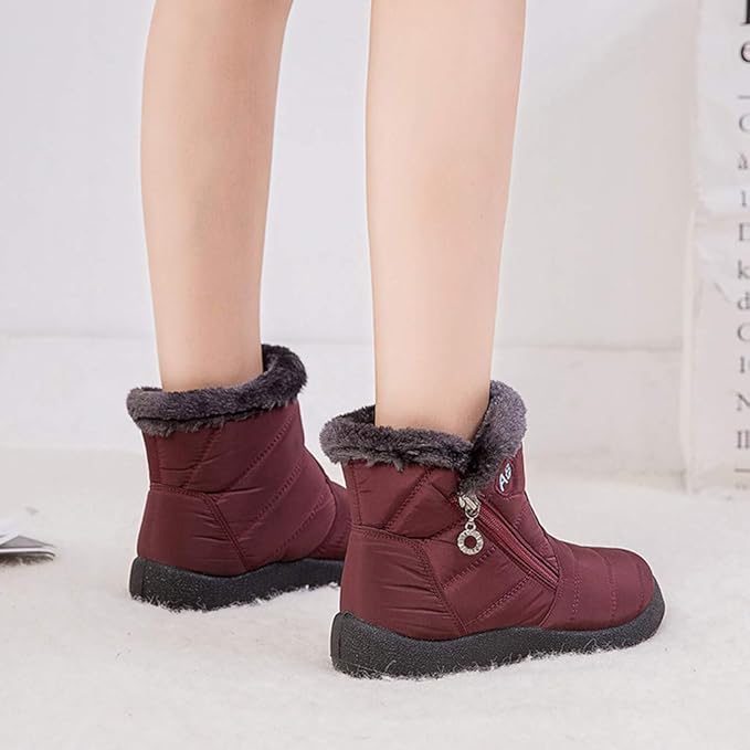 Marcelline brown ankle snow boots with fur collar, pair on flooring
