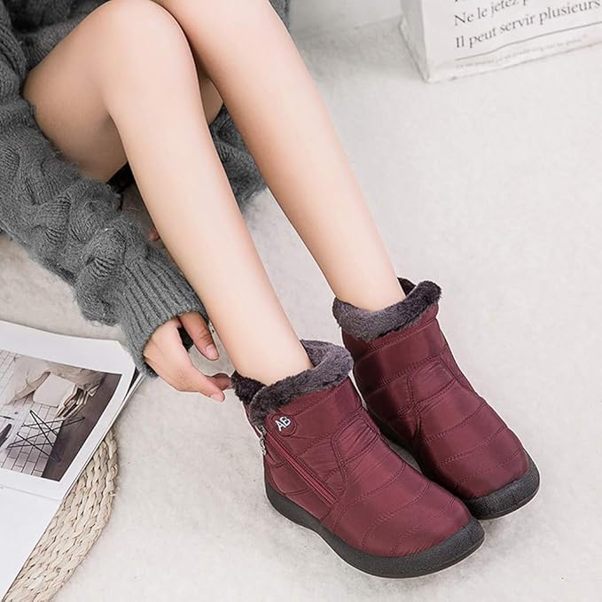 Marcelline brown ankle snow boots with fur collar, pair on flooring