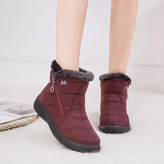 Marcelline brown ankle snow boots with fur collar, pair on flooring