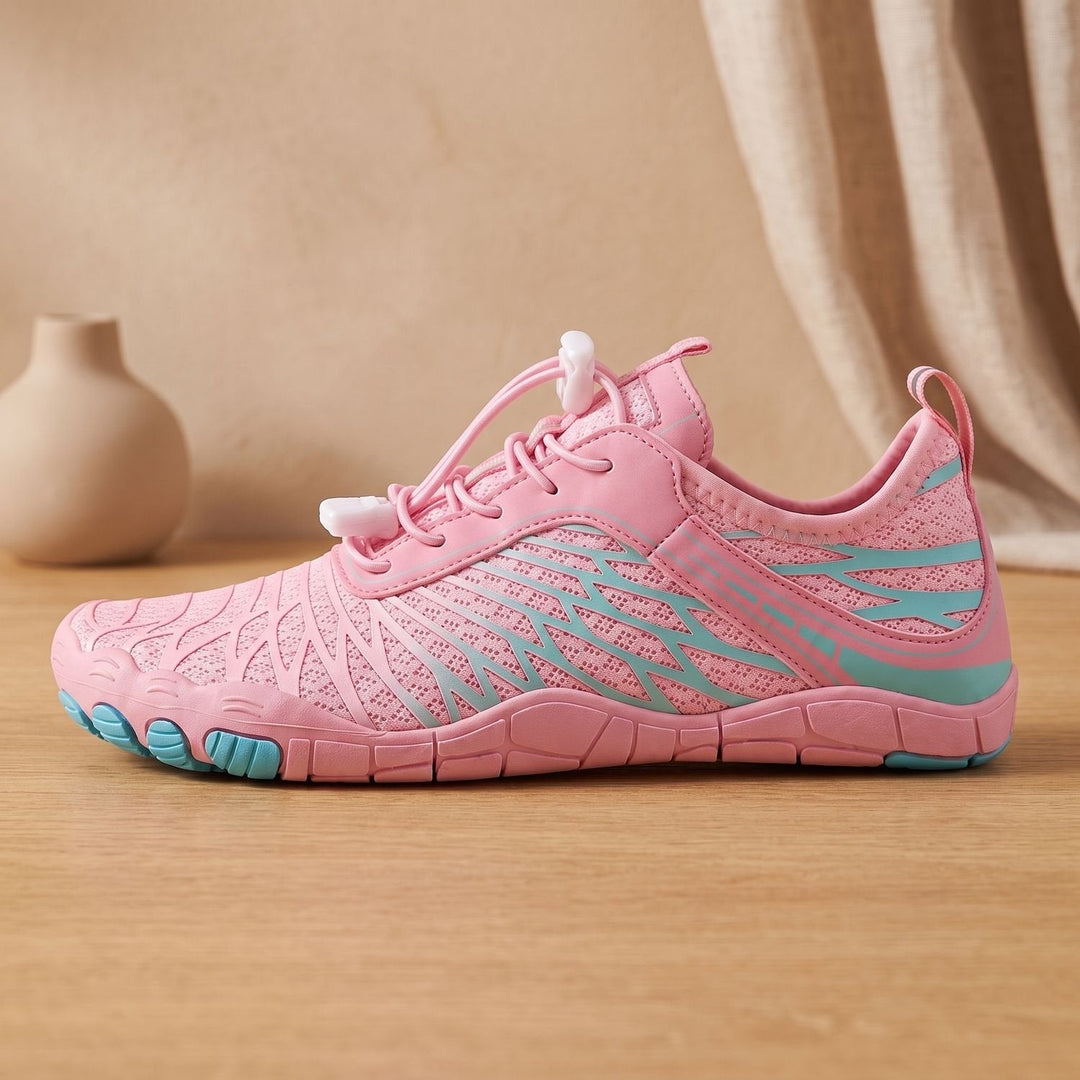 Marisela pink walking sneaker, side profile on wooden surface