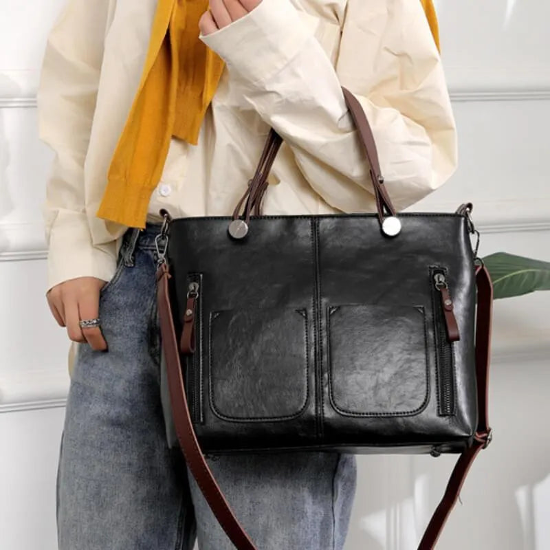 Marguerite tote bag carried on arm in black