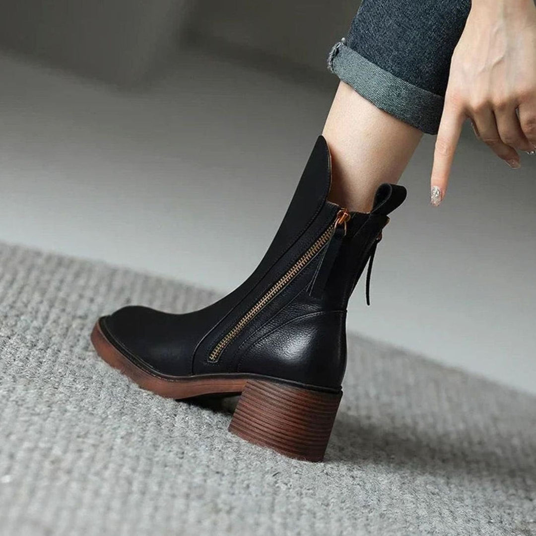 Priscilla black ankle boot worn on foot, close-up back view with zip detail