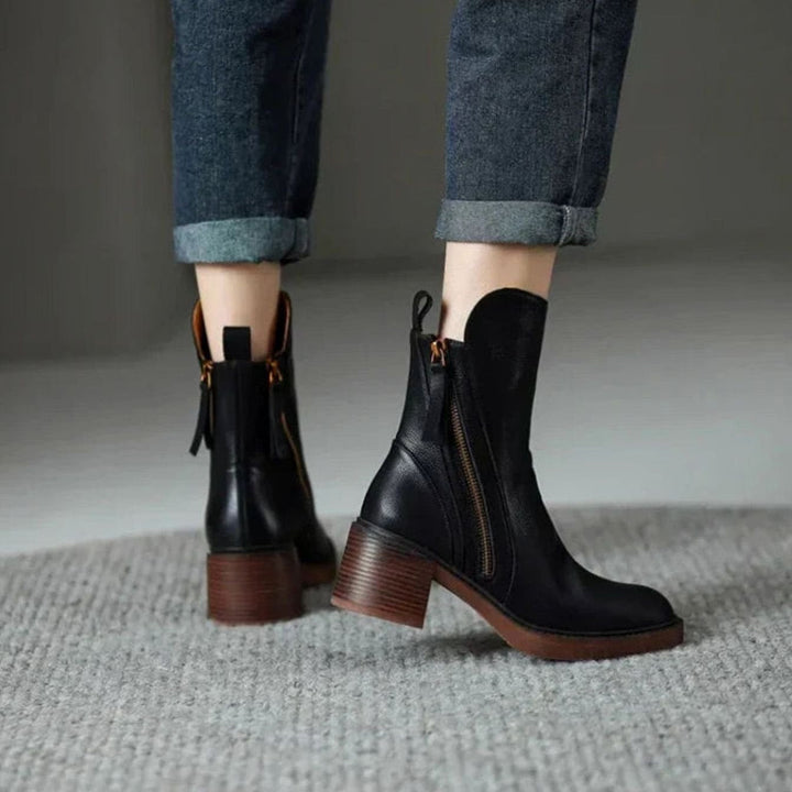 Priscilla black ankle boots worn with rolled denim, walking view