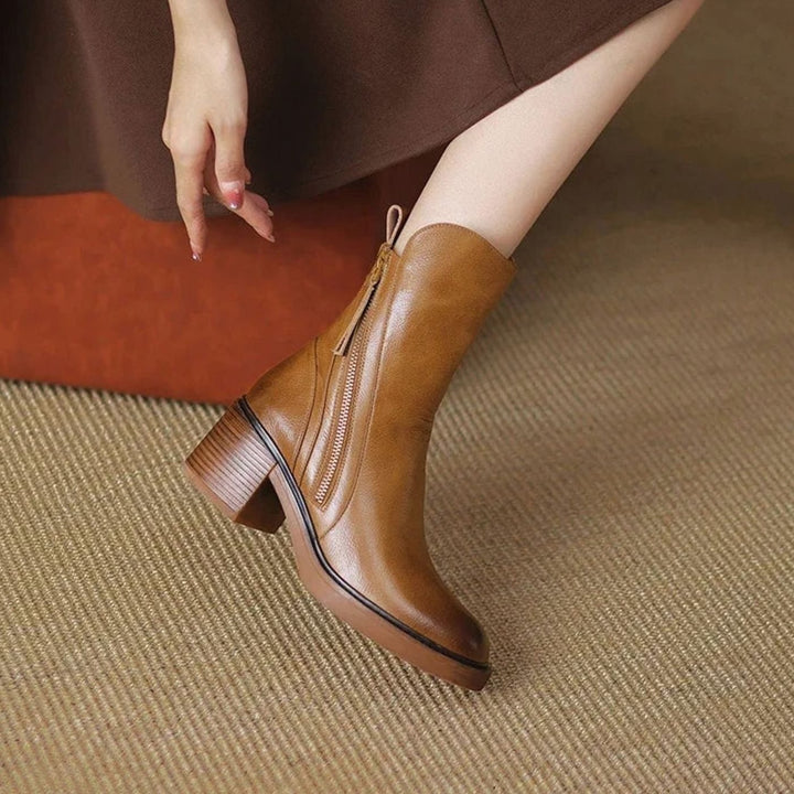 Priscilla brown zip-up block heel ankle boot worn under skirt