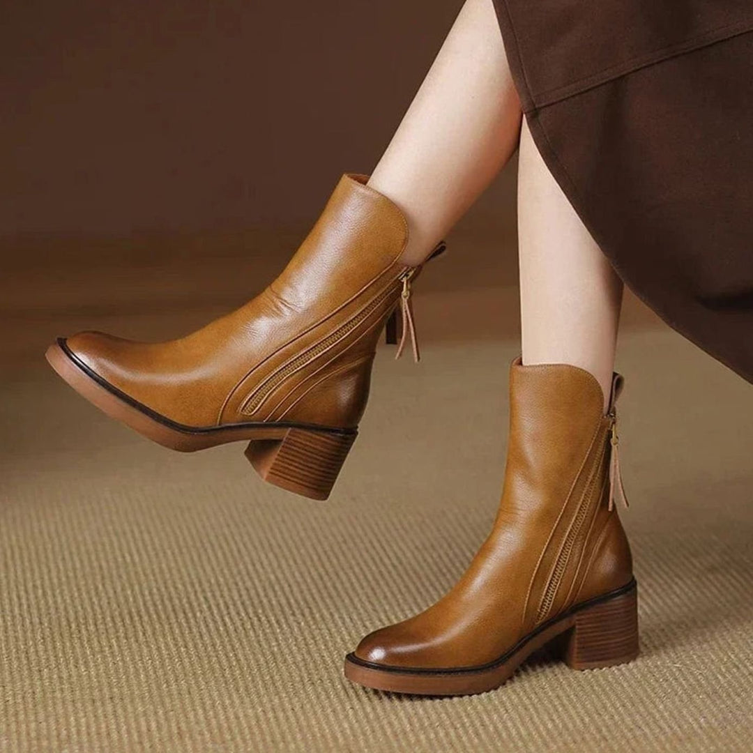 Priscilla brown zip-up block heel ankle boot worn under skirt