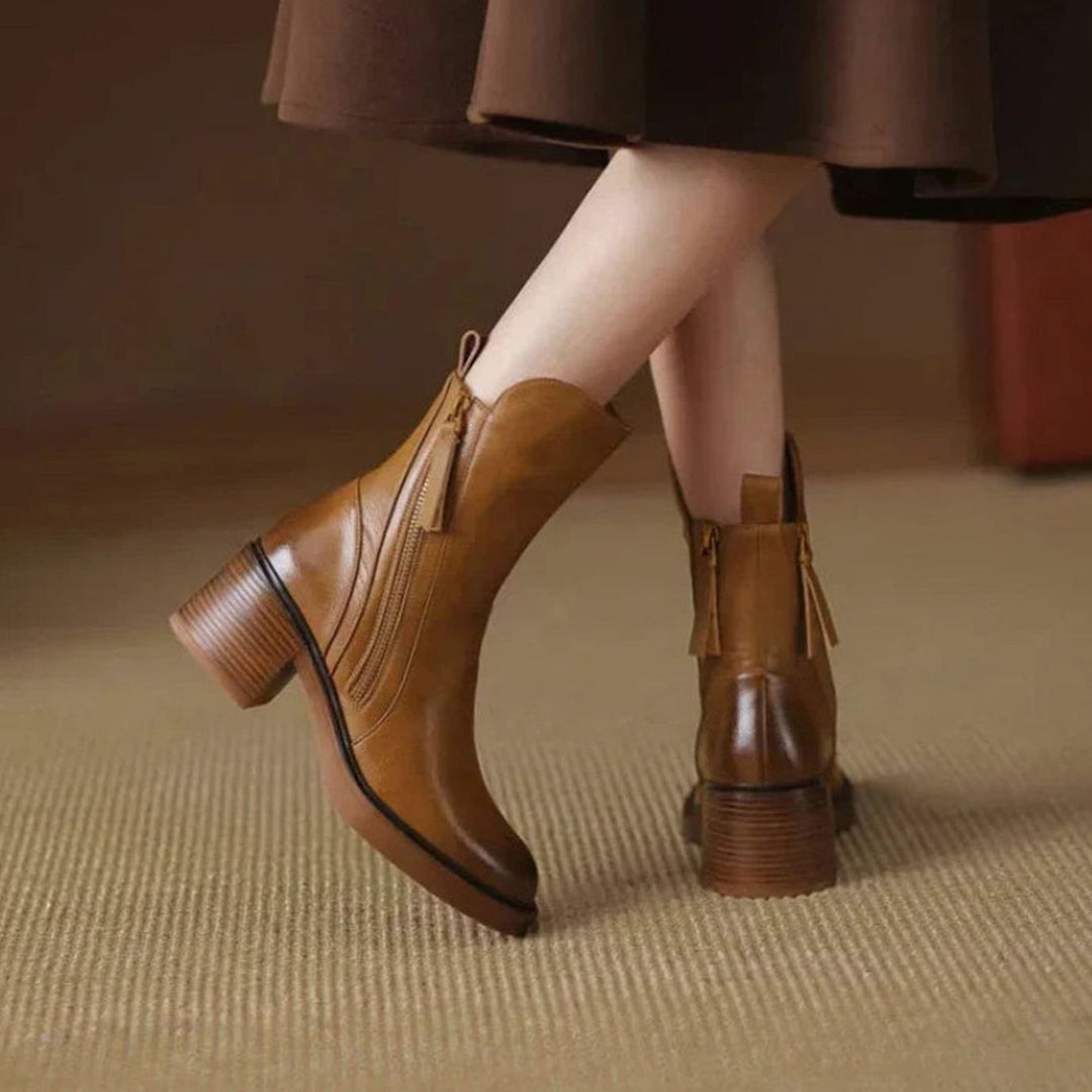 Priscilla brown zip-up block heel ankle boot worn under skirt