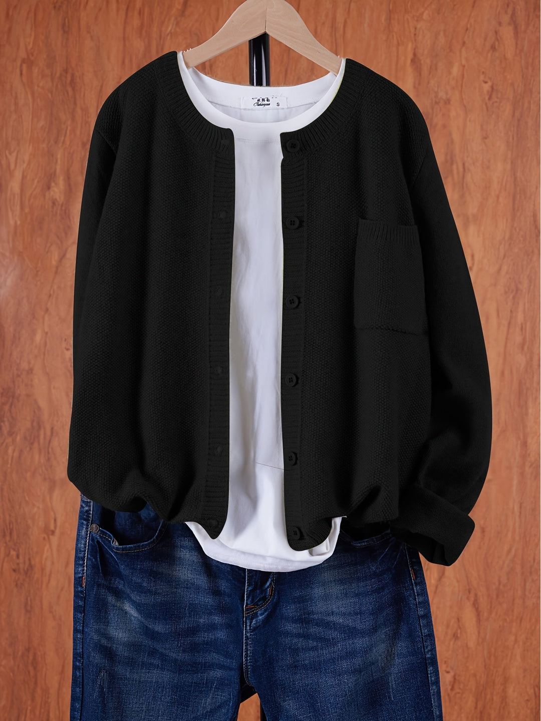 Wren relaxed button-front cardigan in black, front view on hanger