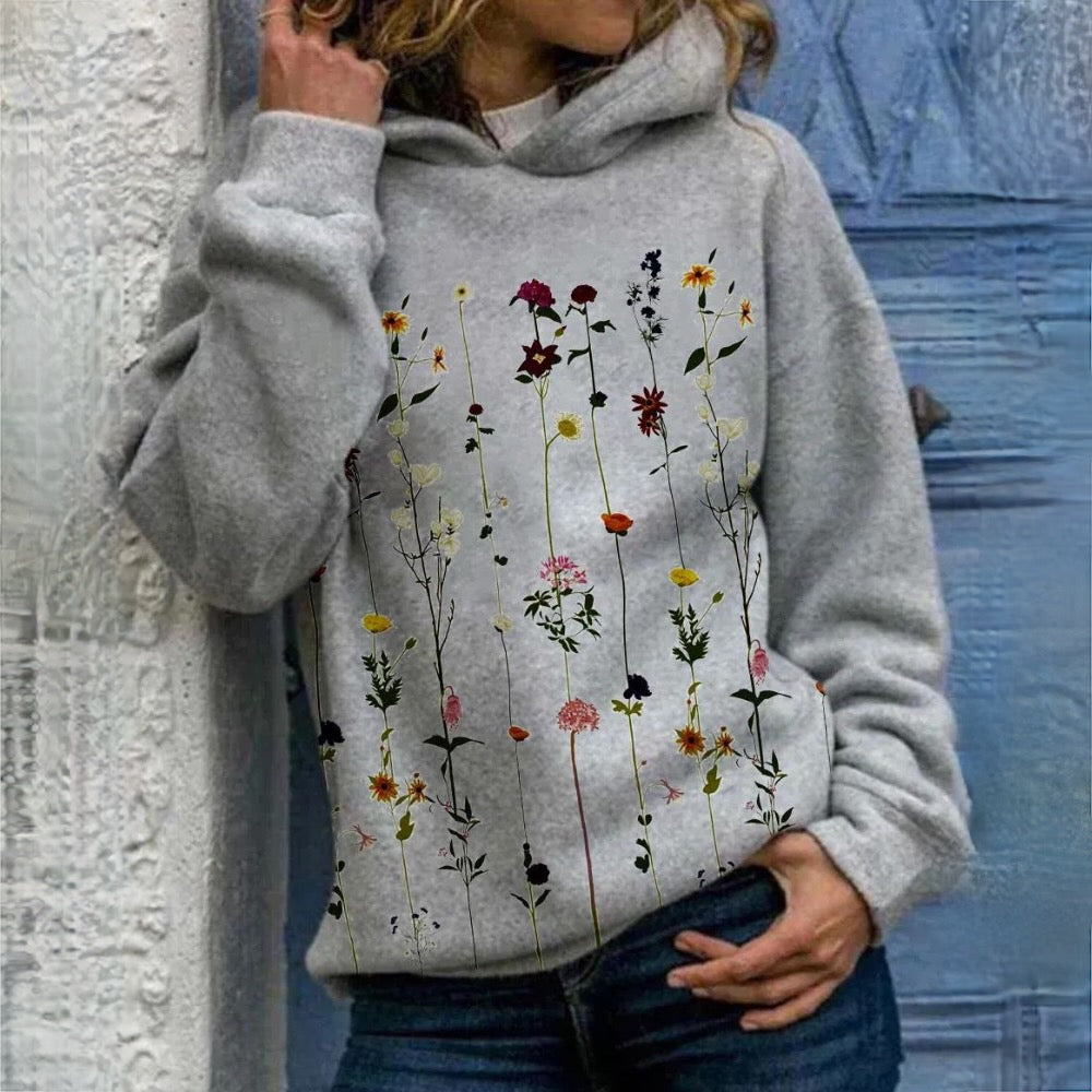 Wren wildflower print long sleeve hoodie, front view close-up on model