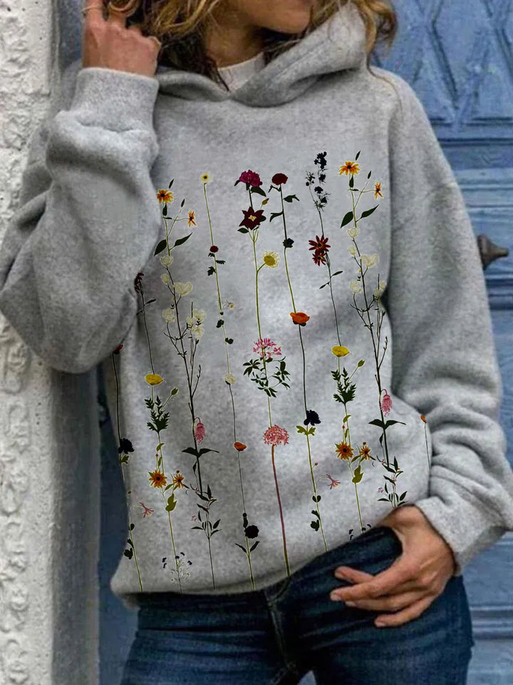 Wren wildflower print long sleeve hoodie, front view against blue door background